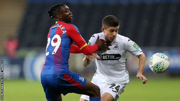 Crystal Palace defender Aaron Wan-Bissaka challenges Declan John of Swansea City