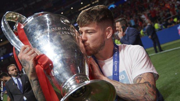 Alberto Moreno holding the Champions League trophy