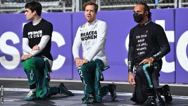 Lance Stroll, Sebastien Vettel and Lewis Hamilton taking a knee