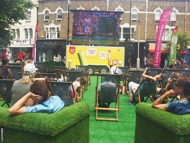 A high street has a Wimbledon big screen to watch
