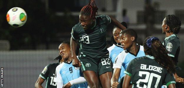 Christy Ucheibe heads in a goal for Nigeria