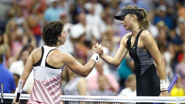 Carla Suarez Navarro and Maria Sharapova shake hands over the net after their last-16 match on Monday