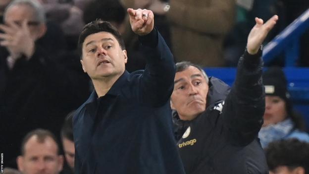 Mauricio Pochettino and his assistant gesture instructions from the side line
