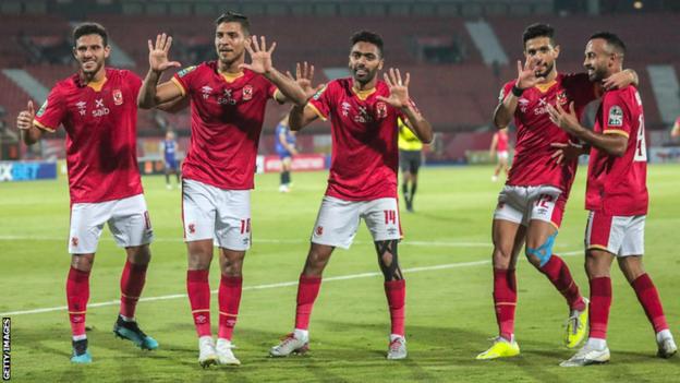 Al Ahly's players show the number "10" with their hands as they celebrate after winning the second leg of the African Champions League semi-final football against Esperance as they aim to win their club's tenth Champions League title.