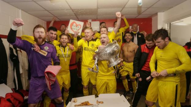 Cliftonville players celebrate in the dressing room after their League Cup final success against Ards