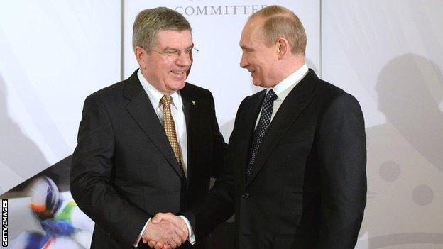 President of the International Olympic Committee (IOC), Thomas Bach (L) shakes hands with Russian President Vladimir Putin on the eve of the 2014 Winter Olympics on February 6, 2014 in Sochi, Russia.