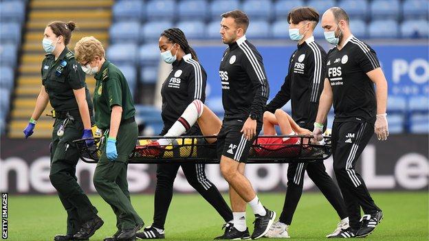 Millie Turner is carried off on a stretcher