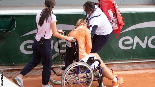 Kiki Bertens leaves court in wheelchair