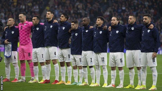 Israel players line up for their national anthem at Hampden on 9 October