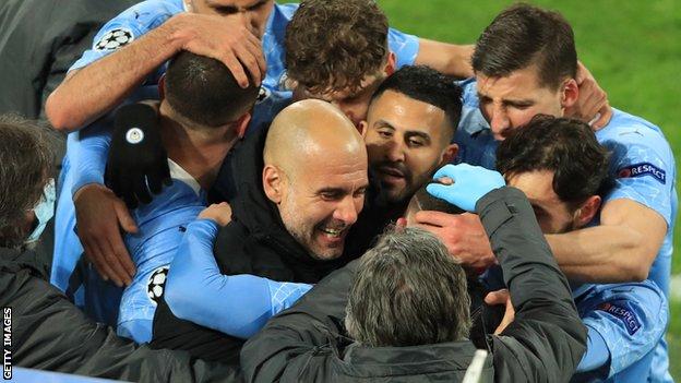 Manchester City players and manager Pep Guardiola celebrate Phil Foden's goal