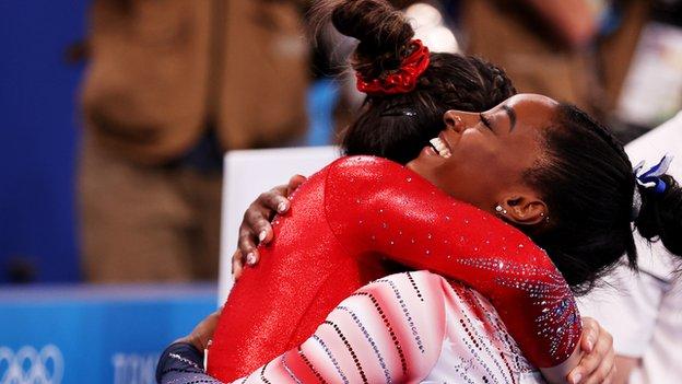 Simone Biles hugs USA team-mate Sunisa Lee