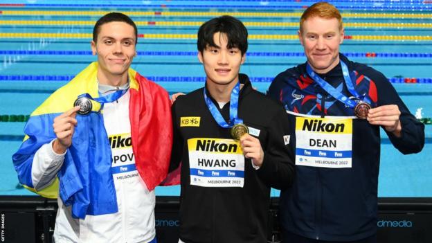 : Silver medallist David Popovici of Romania, Gold medallist Hwang Sun-woo of South Korea and Bronze medallist Tom Dean