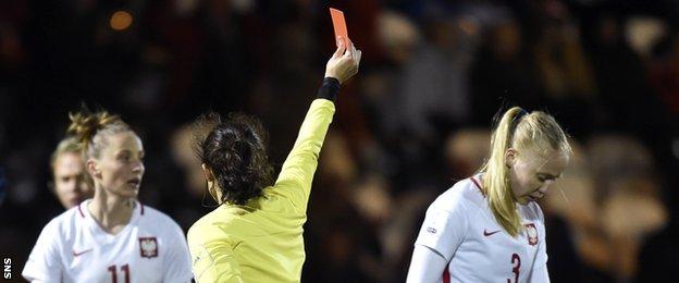Poland's Paulina Dudek is shown the red card