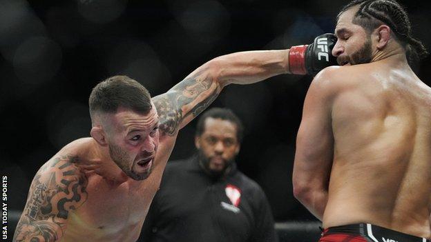 Colby Covington (red gloves) fights Jorge Masvidal (blue gloves) during UFC 272 at T-Mobile Arena