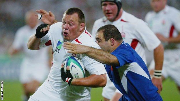 Steve Thompson is tackled while playing for England