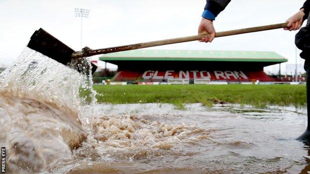 Water is cleared from the Oval pitch earlier this week