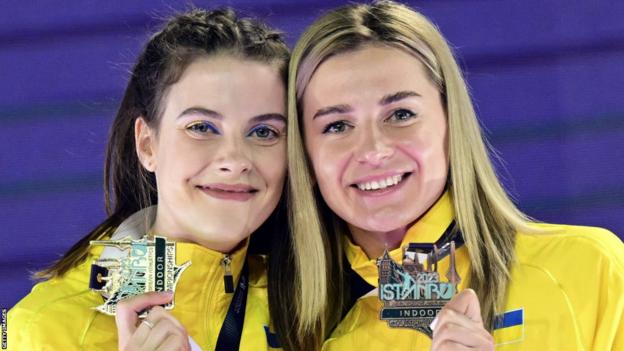 Ukraine's Yaroslava Mahuchikh and Kateryna Tabashnyk celebrate their medals