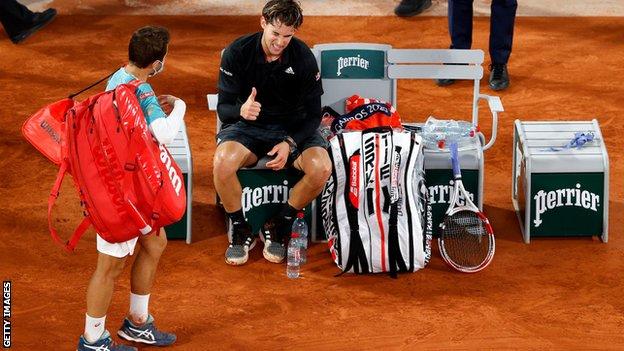 Dominic Thiem gives a thumbs-up gesture to opponent Hugo Gaston after the match