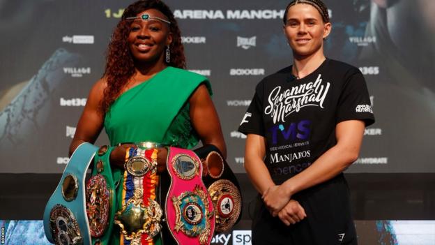 Franchon Crews-Dezurn with her belts poses beside Savannah Marshall