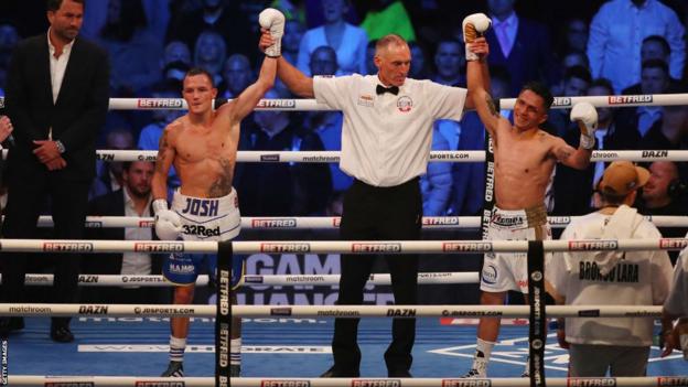 Josh Warrington and Mauricio Lara have their hands raised in the ring by the referee