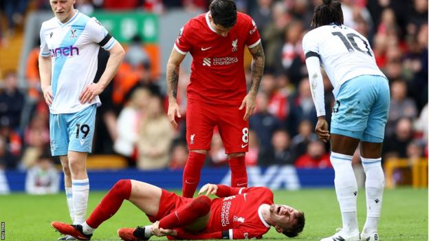 Liverpool right-back Conor Bradley on the floor in pain after being injured