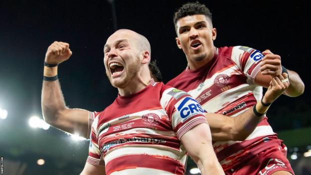Liam Marshall (left) celebrates scoring a try for Wigan Warriors