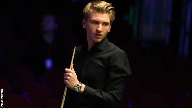 Iulian Boiko holds his snooker cue