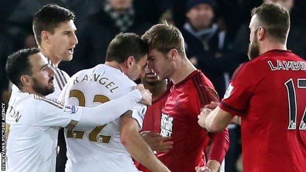 Swansea's Angel Rangel and Callum McManaman of West Brom clash during the Swans' 1-0 win