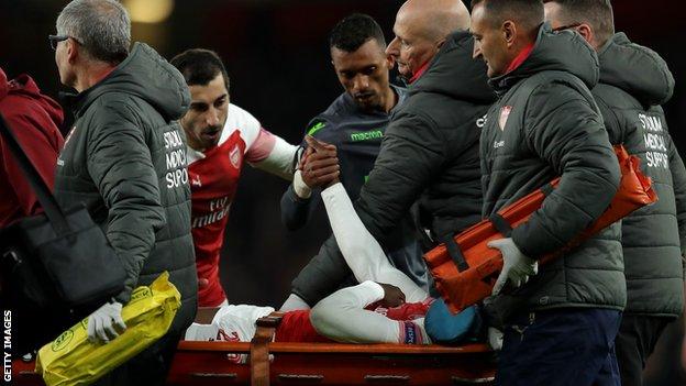 Danny Welbeck is carried off the pitch on a stretcher