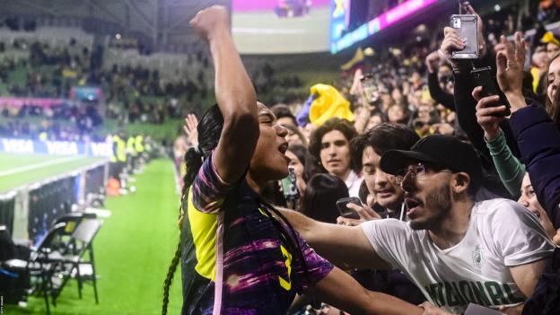 Colombia defender Daniella Arias celebrates with supporters astatine  Melbourne Rectangular Stadium aft  they bushed  Jamaica