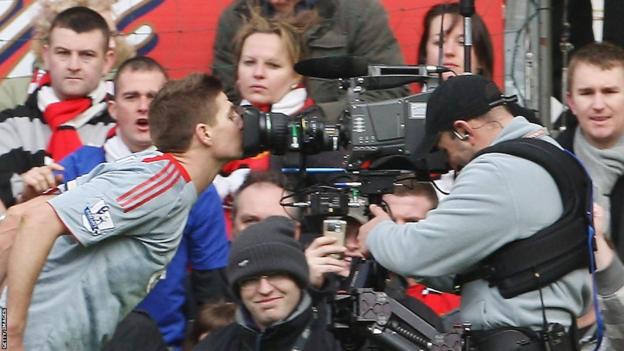 Steven Gerrard celebrates by kissing a TV camera