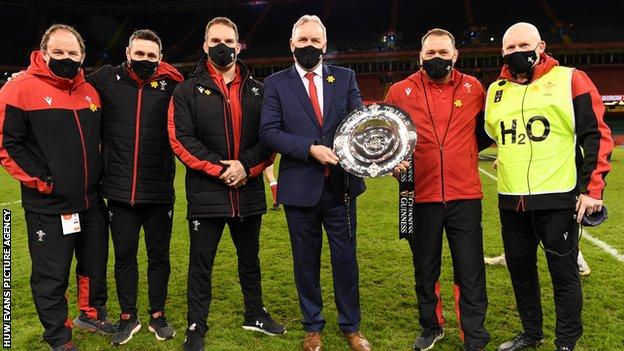 Wales coaches celebrate with the Triple Crown after victory over England