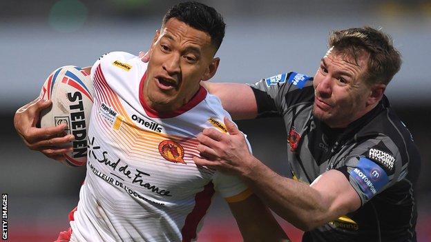 Israel Folau of Catalans Dragons is challenged by Michael Shenton of Castleford Tigers