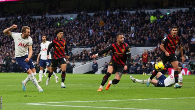 Harry Kane scores for Tottenham against Manchester City in the Premier League