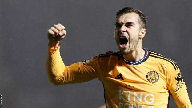 Harry Winks celebrates a goal for Leicester by punching the air