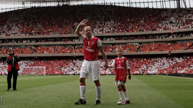 Mitchel Bergkamp - aged seven - holds his dad's hand as Arsenal fans show their appreciation for Dennis Bergkamp at his testimonial in 2006