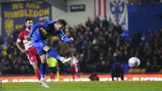 Jake Reeves of AFC Wimbledon scores the opening goal against Ramsgate in the FA Cup