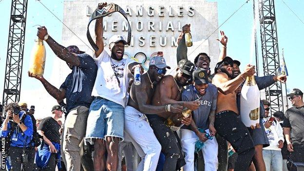 Los Angeles Rams players celebrating after their trophy parade