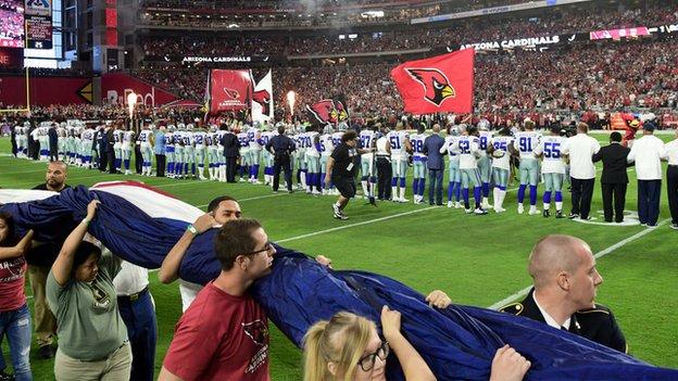 Cowboys players standing during the National Anthem before Sunday's Cowboys-Bears  game.