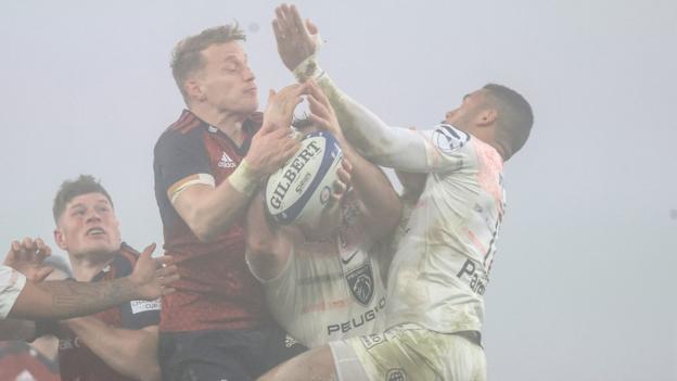 The fog descends on Thomond Park as Munster's Mike Haley challenges Matthis Lebel for the ball