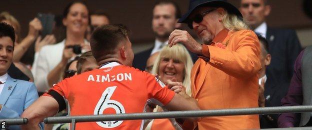 Blackpool's Will Aimson shakes hands with Owner Owen Oyston after the final whistle