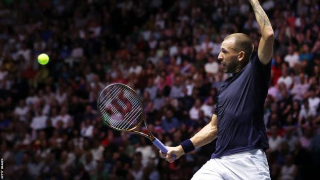 Great Britain's Dan Evans hits a return in the Davis Cup tie against France