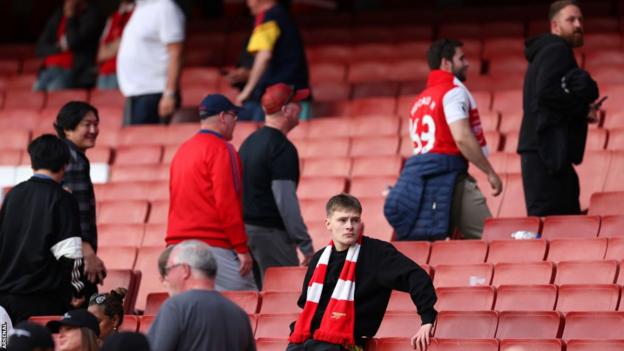 Arsenal fans look dejected as they leave the Emirates following the 3-0 home loss to Brighton