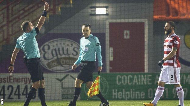 Referee Gavin Duncan shows a red card to Hamilton defender Giannis Skondras