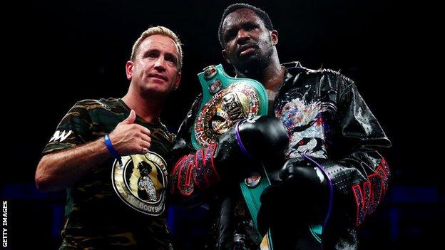 Dillian Whyte poses with her trainer Mark Tibbs with her belt