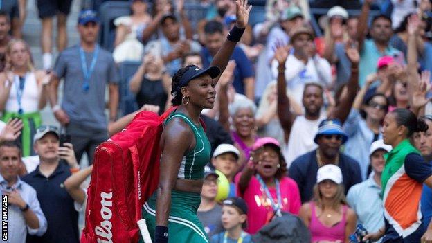 Venus Williams waves to the crowd as she leaves Arthur Ashe Stadium