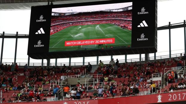 A screen displays information that the match kick-off has been delayed by 30 mins, ahead of the English Premier League football match between Arsenal and Nottingham Forest at the Emirates Stadium