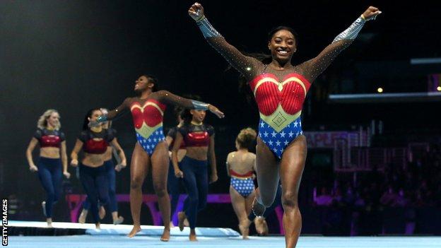 Simone Biles performs in a wonder woman outfit