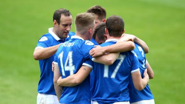 Linfield players gather to congratulate hat-trick hero Andrew Waterworth after he scored the second of his three goals against Dungannon Swifts