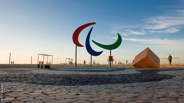 The Paralympic symbol, displayed at Copacabana beach during a sunrise